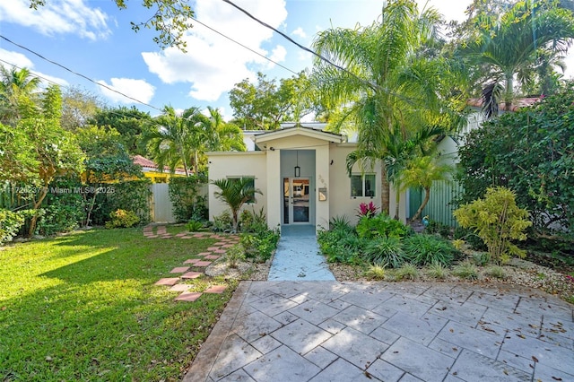 view of front of property featuring a front lawn and a patio area