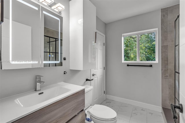 bathroom with a shower with shower door, vanity, and toilet