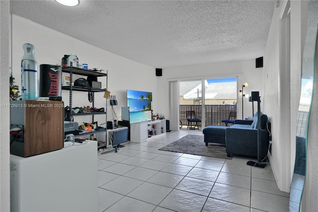 living room featuring a textured ceiling and light tile patterned floors