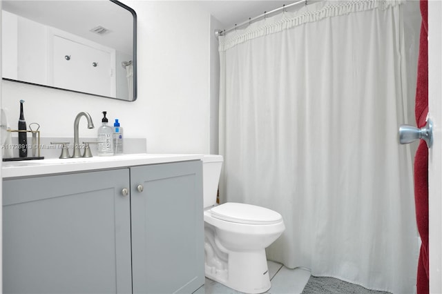 bathroom featuring toilet, vanity, and tile patterned flooring