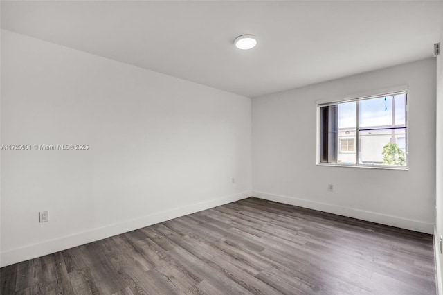 unfurnished room with hardwood / wood-style flooring