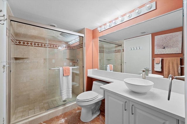 bathroom with toilet, tile patterned floors, a shower with shower door, and vanity