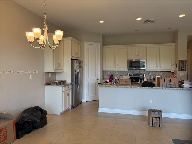 kitchen featuring pendant lighting, appliances with stainless steel finishes, kitchen peninsula, light tile patterned flooring, and light stone counters