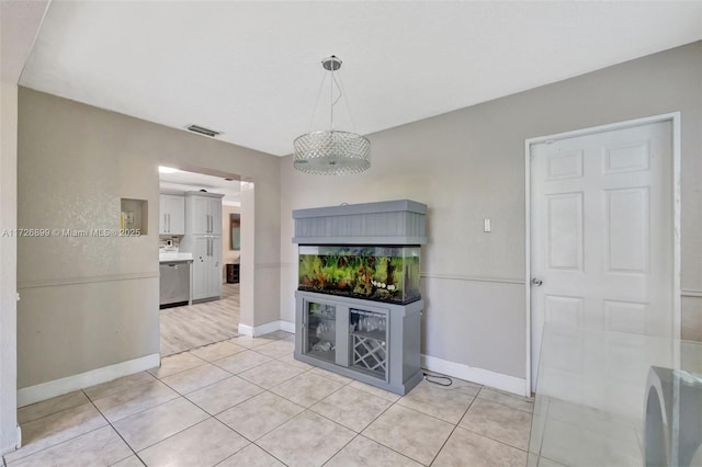 unfurnished dining area with light tile patterned floors