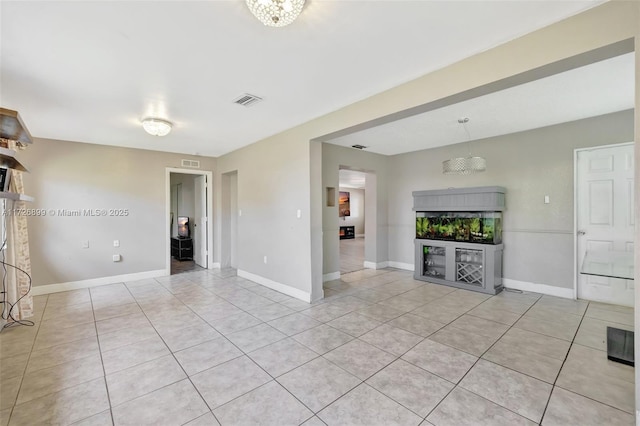 unfurnished living room with light tile patterned floors