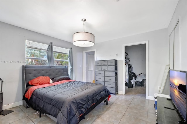 tiled bedroom with a closet