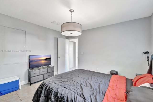 bedroom with light tile patterned floors