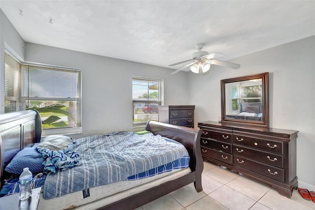 bedroom with ceiling fan and light tile patterned floors