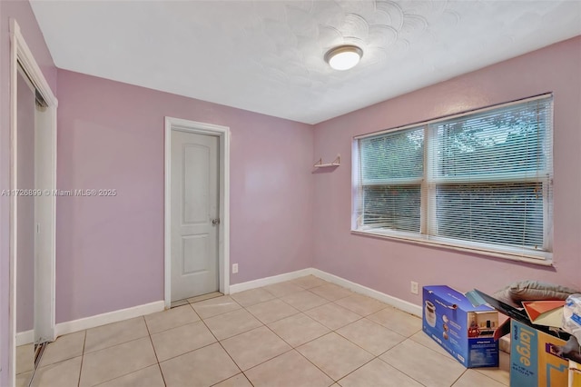 empty room with light tile patterned flooring