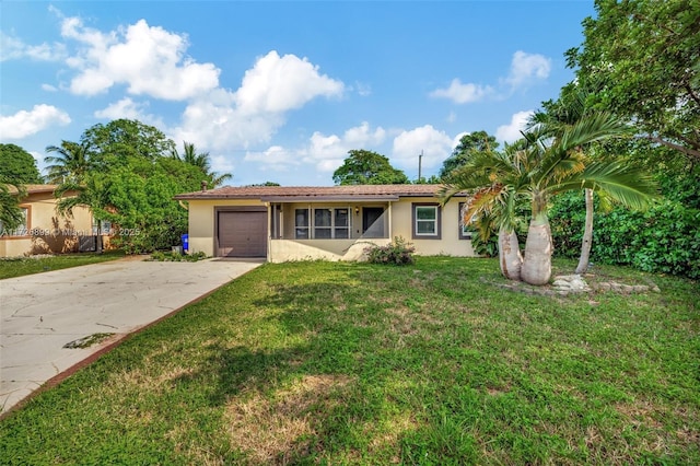 ranch-style house featuring a front lawn and a garage