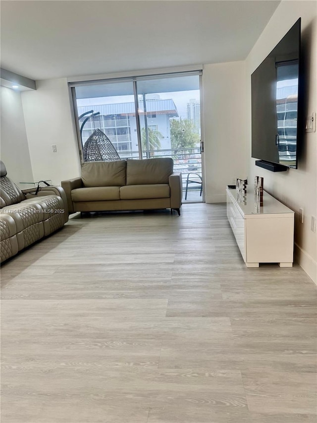 3725 NE 169th St Unit B-203, North Miami Beach, FL 33160 - living room with light wood-style floors