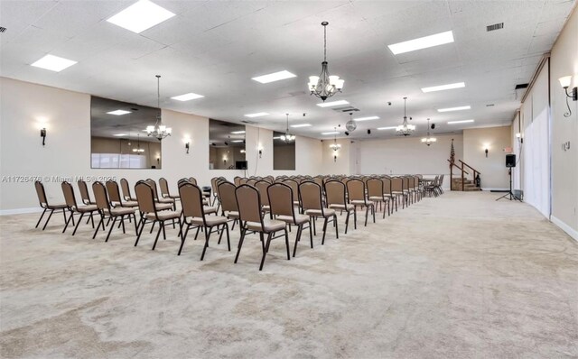 miscellaneous room with light carpet and a chandelier