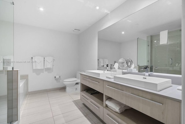 full bathroom with separate shower and tub, vanity, tile patterned floors, and toilet