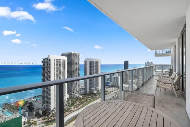 balcony with a water view and central air condition unit