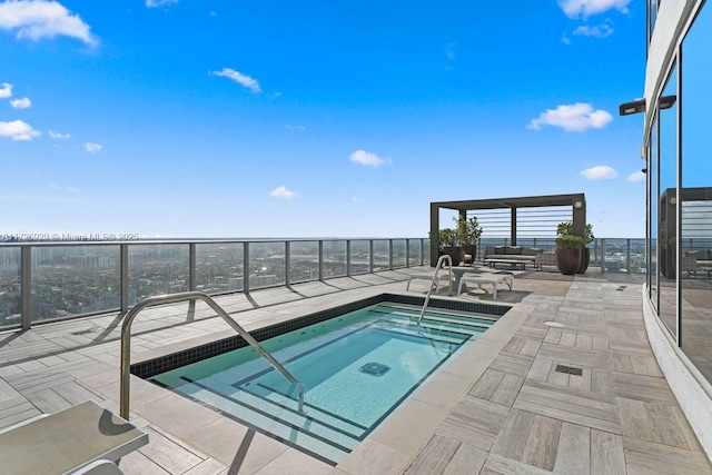 view of swimming pool featuring a patio and an in ground hot tub