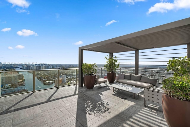 wooden terrace featuring a water view and an outdoor hangout area