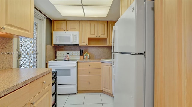 kitchen with light brown cabinetry, white appliances, light tile patterned floors, and decorative backsplash