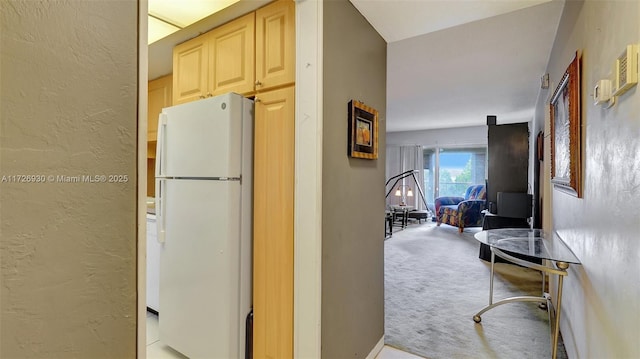 kitchen with light carpet and white fridge