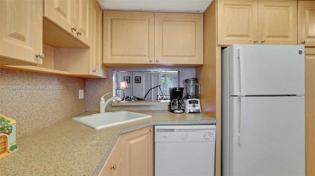 kitchen featuring light brown cabinets, sink, tasteful backsplash, and white appliances