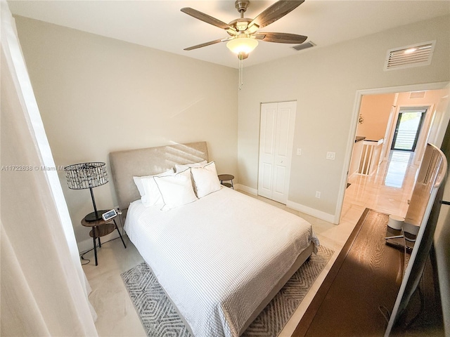 bedroom with ceiling fan and a closet