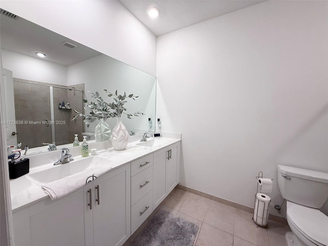 bathroom featuring toilet, vanity, tile patterned flooring, and an enclosed shower