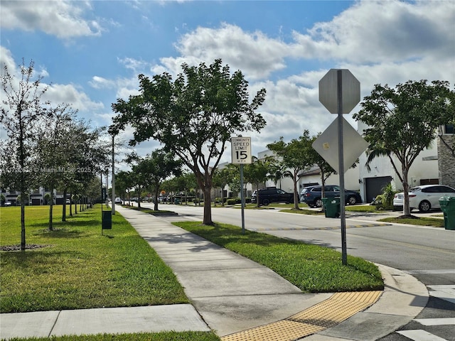 view of property's community featuring a lawn