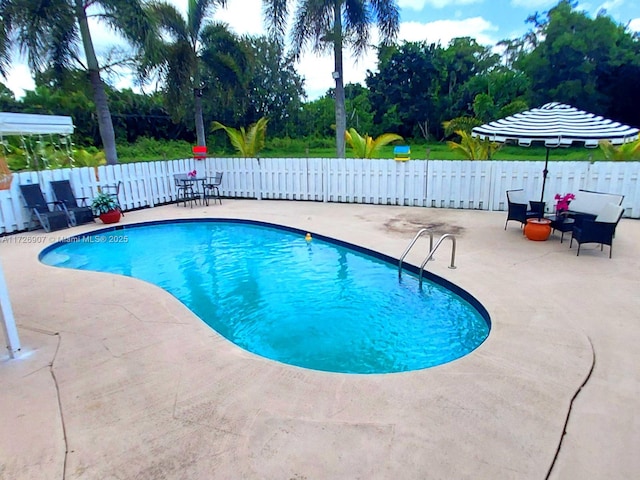 view of pool with a patio area and a wall mounted air conditioner