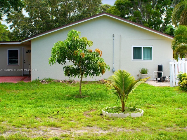 view of side of home featuring a lawn