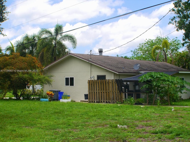 view of side of home featuring a yard