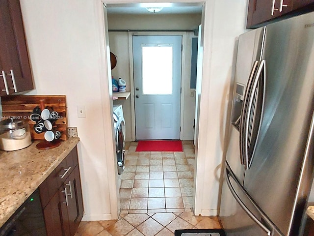 kitchen with stainless steel fridge with ice dispenser, dark brown cabinets, and washing machine and dryer