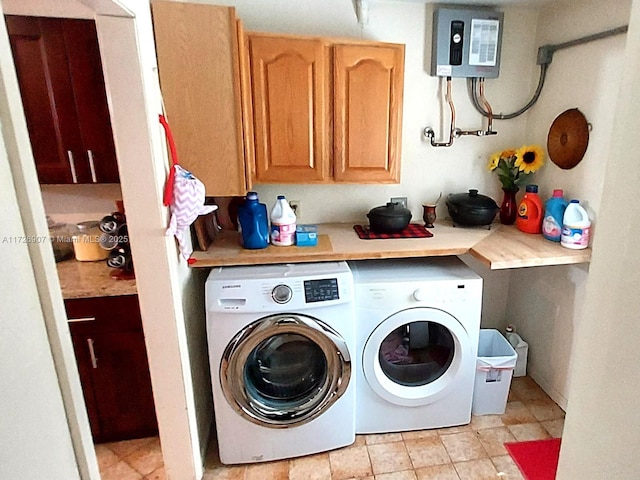 washroom featuring cabinets and washer and clothes dryer