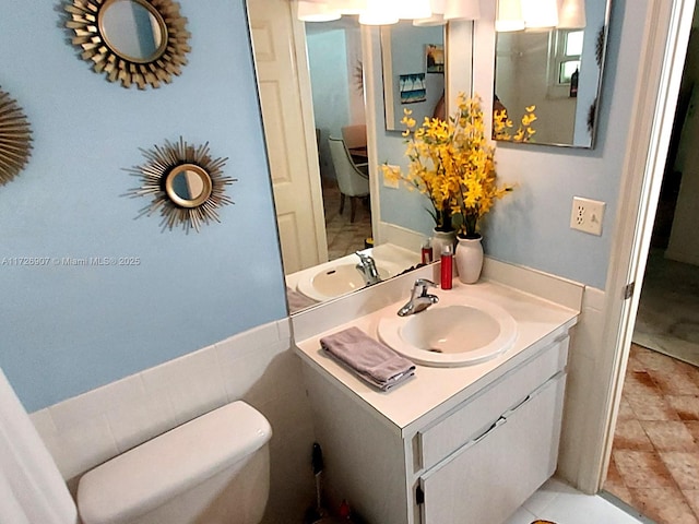 bathroom with toilet and vanity