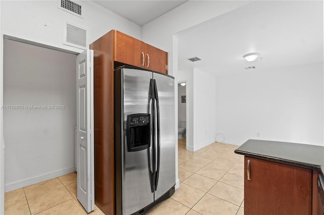 kitchen with light tile patterned floors and stainless steel refrigerator with ice dispenser