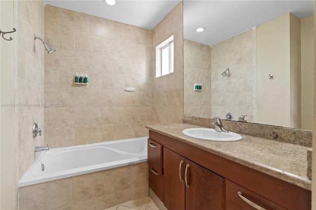 bathroom with tile patterned floors, tiled shower / bath combo, vanity, and tile walls