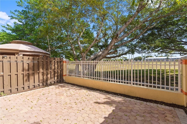 view of gate with a patio