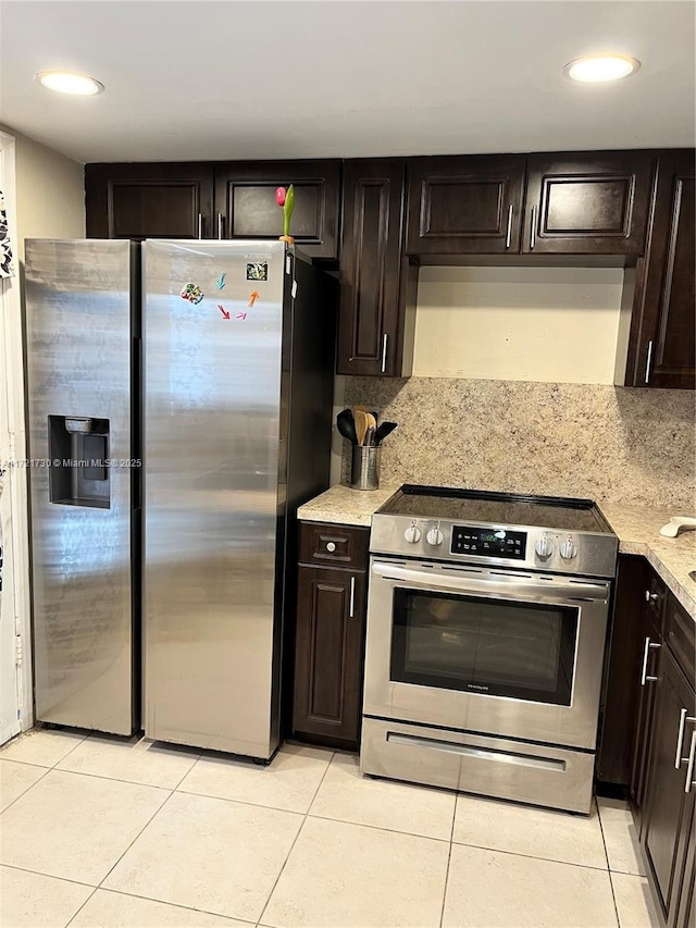 kitchen featuring decorative backsplash, light tile patterned floors, dark brown cabinetry, and appliances with stainless steel finishes