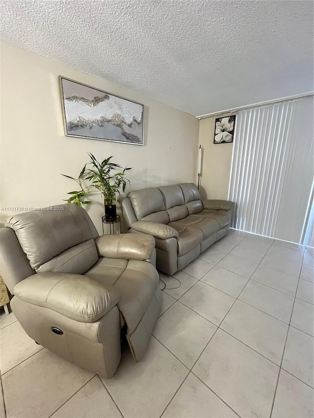 tiled living room featuring a textured ceiling