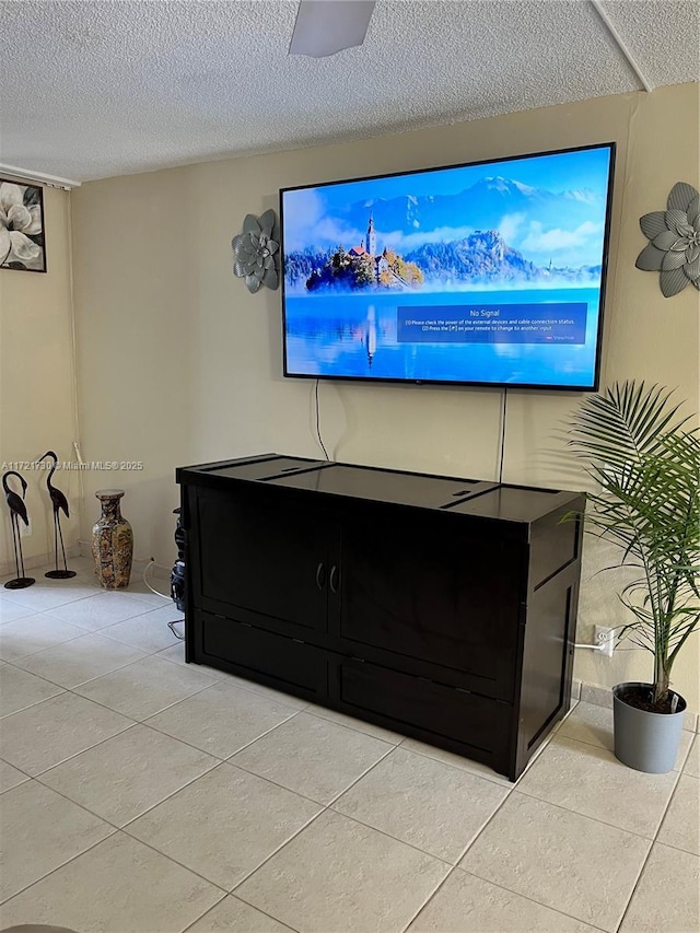 tiled living room featuring ceiling fan and a textured ceiling