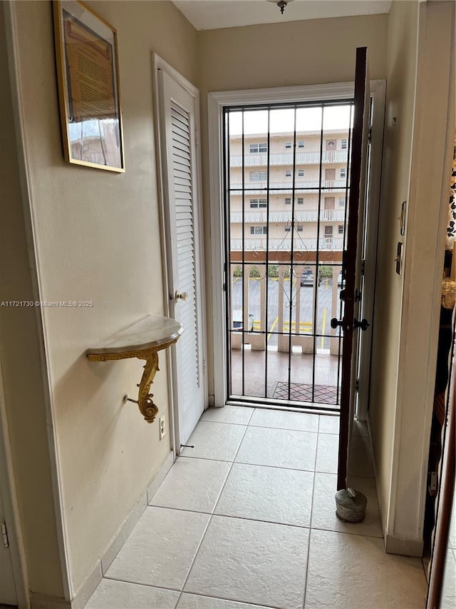 doorway to outside with light tile patterned floors