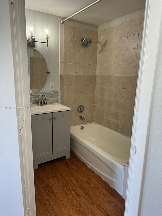 bathroom with shower / bath combination, wood finished floors, and vanity