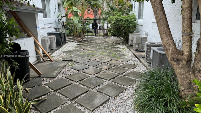 view of patio / terrace featuring central AC unit and fence