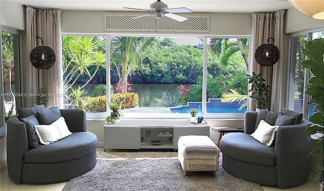 sunroom featuring ceiling fan and a healthy amount of sunlight