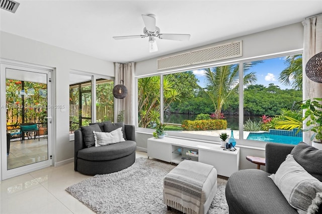 sunroom / solarium featuring ceiling fan