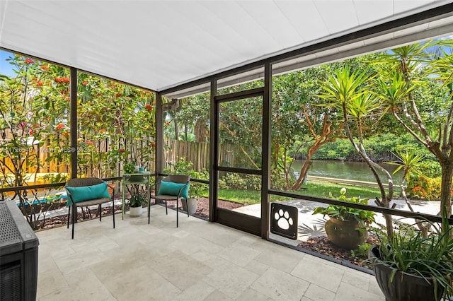 unfurnished sunroom with a water view