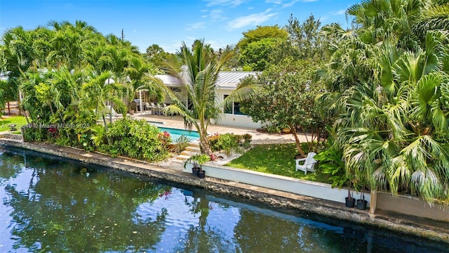 exterior space with a water view and a patio area