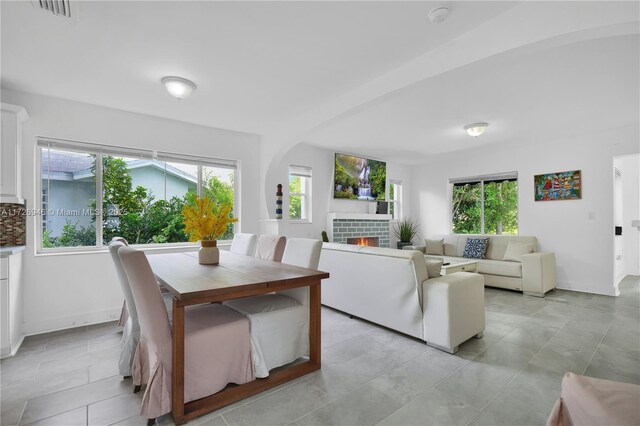 tiled dining area with a fireplace