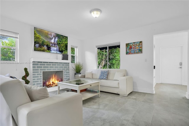 living room with a brick fireplace