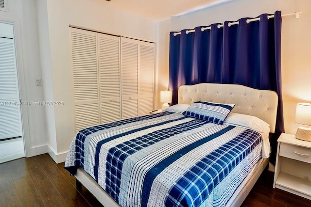 bedroom with a closet and dark wood-type flooring