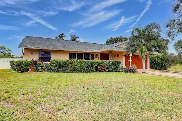 single story home with a garage and a front yard