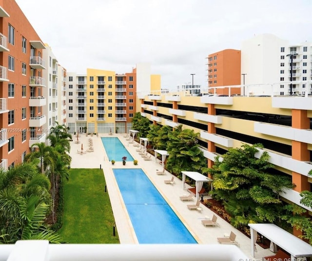 view of swimming pool with a patio area and a lawn